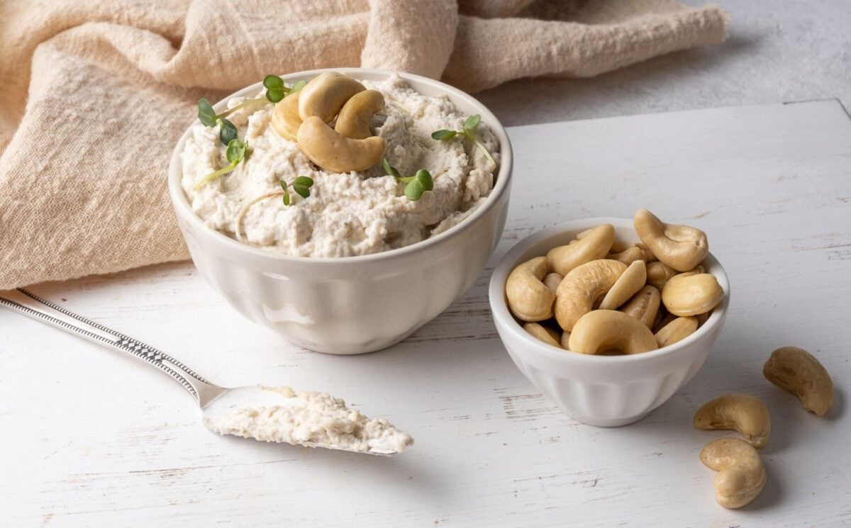 a picture of cashew cream cheese with cashew nuts beside it