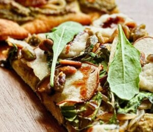 A vegan pistachio and pear pizza made to a plant-based recipe