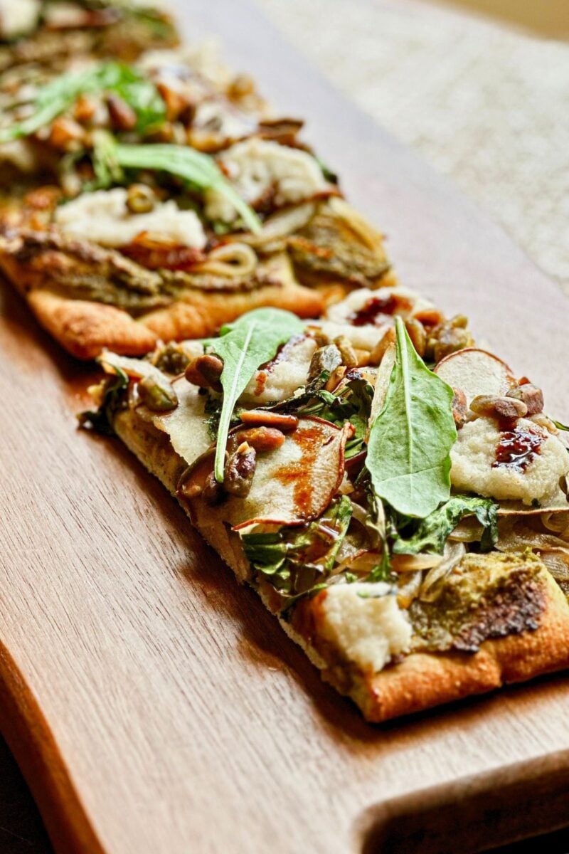 A vegan pistachio and pear pizza made to a plant-based recipe