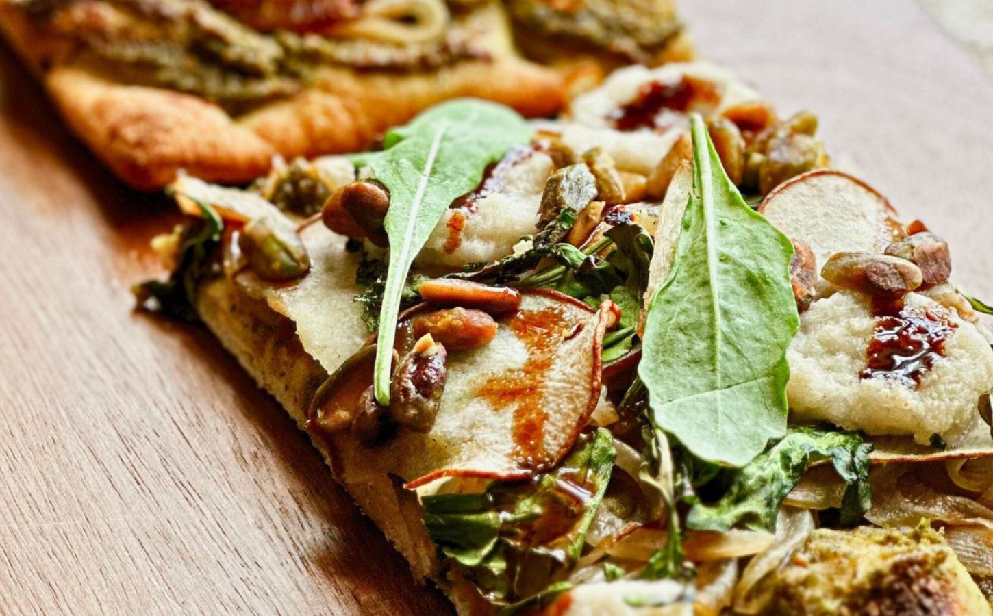A vegan pistachio and pear pizza made to a plant-based recipe