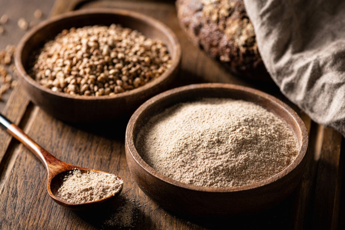 Two bowls of buckwheat, one containing buckwheat flour, a complete plant-based protein source