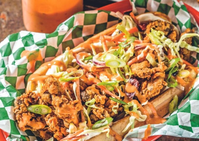 a picture of a classic vegan fried shrimp po' boy made with Mob sauce and coleslaw in a basket