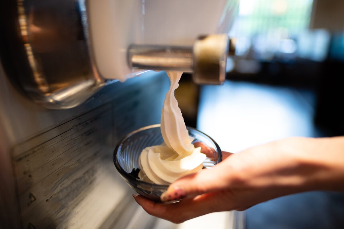 Photo shows someone using a soft serve ice cream machine