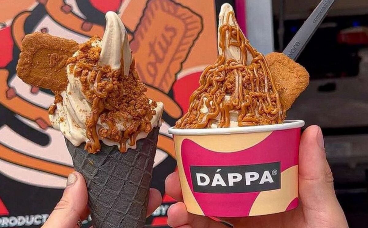 Photo shows two people holding up portions of DÁPPA vegan soft serve together - one in a cone and one in a tub