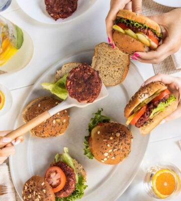 a picture of beauty beet and bean burgers being served to a group