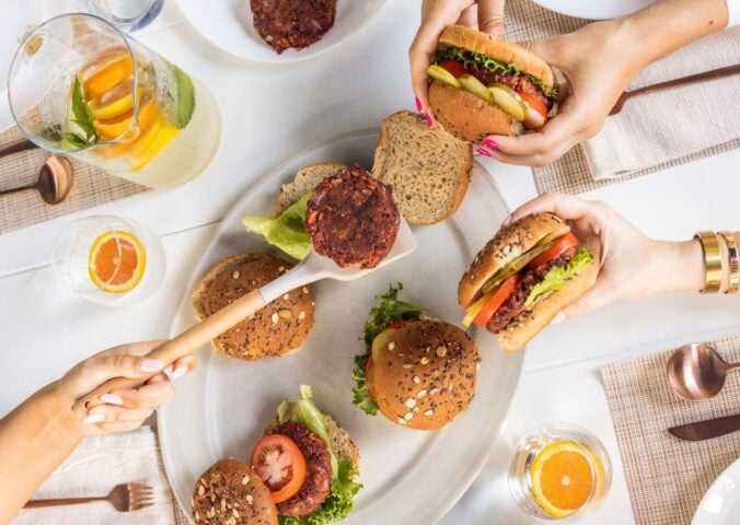 a picture of beauty beet and bean burgers being served to a group