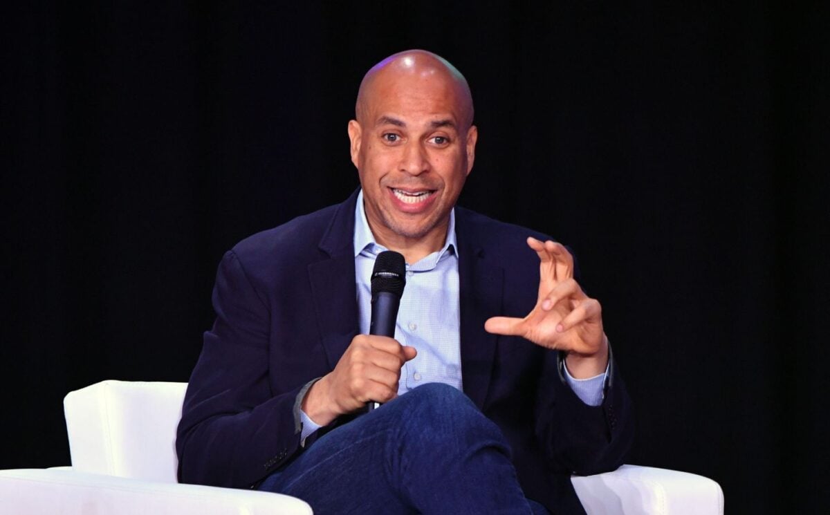 US senator Cory Booker on stage holding a microphone