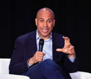 US senator Cory Booker on stage holding a microphone