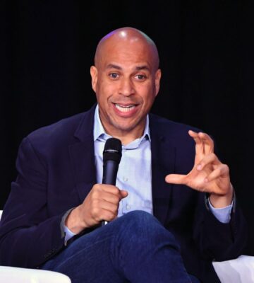 US senator Cory Booker on stage holding a microphone