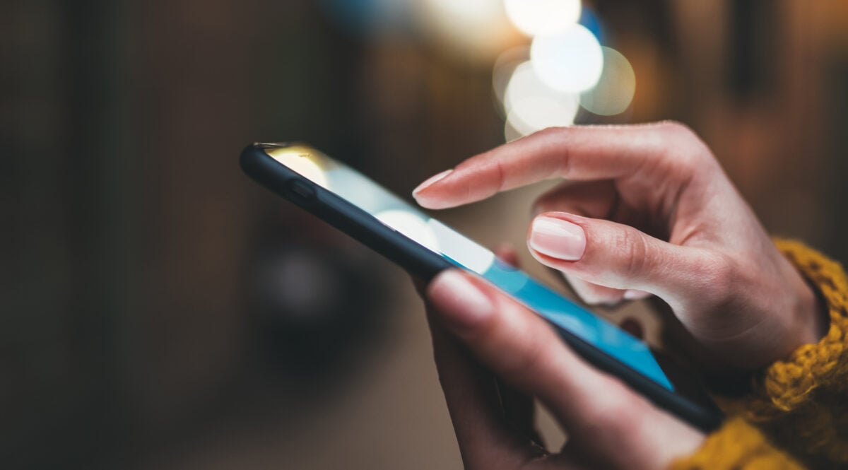 Photo shows someone's hands as they operate a smartphone