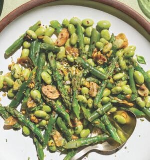 a picture of garlicky asparagus and beans with lemon-infused olive oil as well as, pistachios, garlic chips, and chili