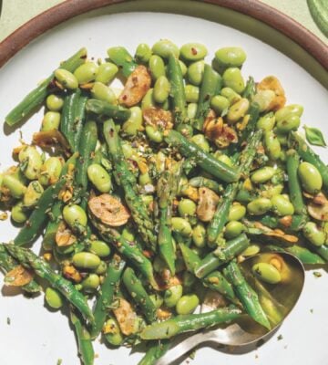 a picture of garlicky asparagus and beans with lemon-infused olive oil as well as, pistachios, garlic chips, and chili