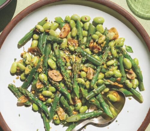 a picture of garlicky asparagus and beans with lemon-infused olive oil as well as, pistachios, garlic chips, and chili