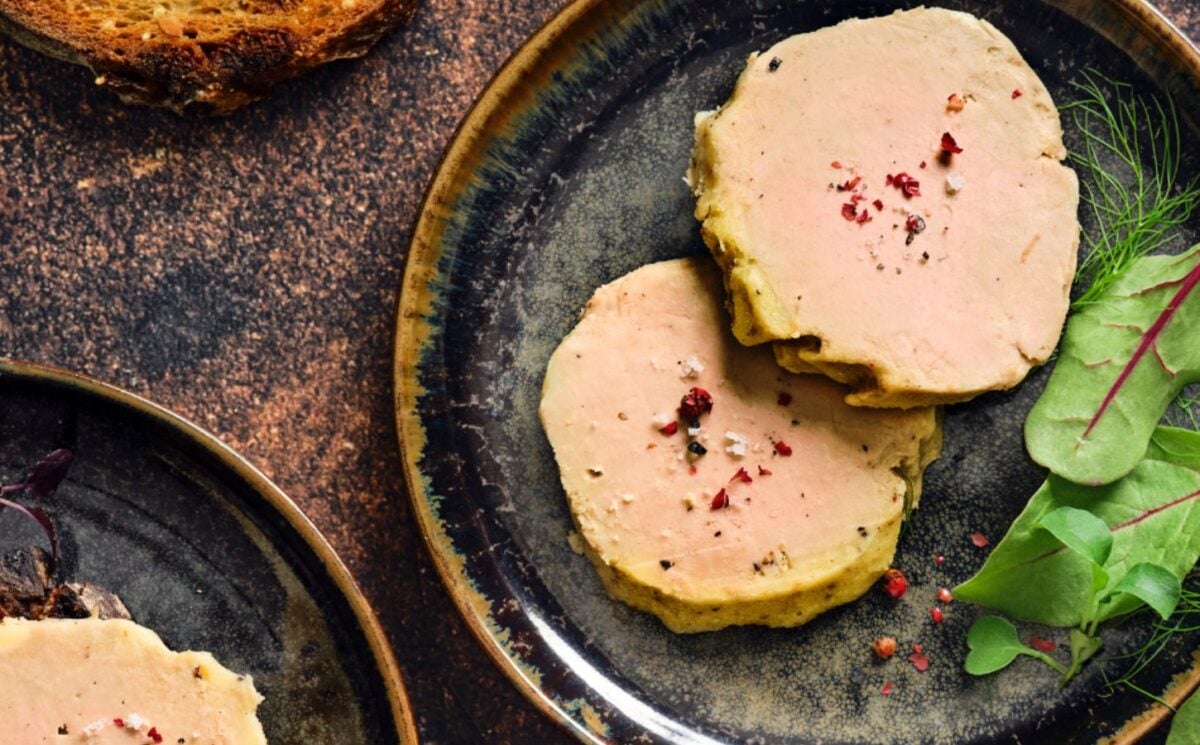 Photo shows a portion of Gourmey's cultivated meat foie gras plated up with some salad leaves