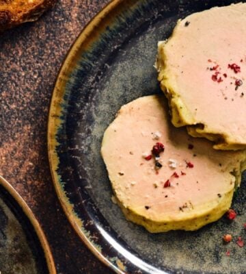 Photo shows a portion of Gourmey's cultivated meat foie gras plated up with some salad leaves