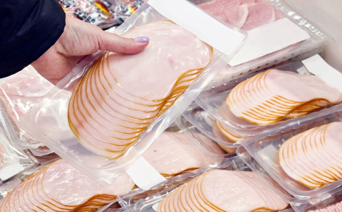 A person picking up slices of ham, which is linked to increased risk of type 2 diabetes, from the supermarket