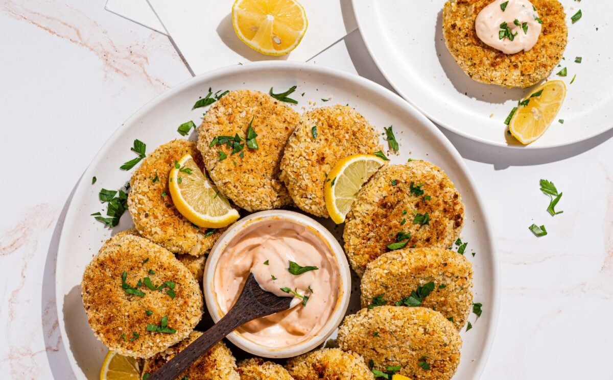 a picture of a plate decorated with hearts of palm crab cakes with a vegan aioli in the middle