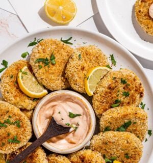 a picture of a plate decorated with hearts of palm crab cakes with a vegan aioli in the middle