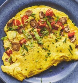 a picture of a vegan omelette folded in half with mushrooms and tomato