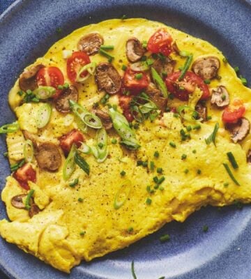 a picture of a vegan omelette folded in half with mushrooms and tomato