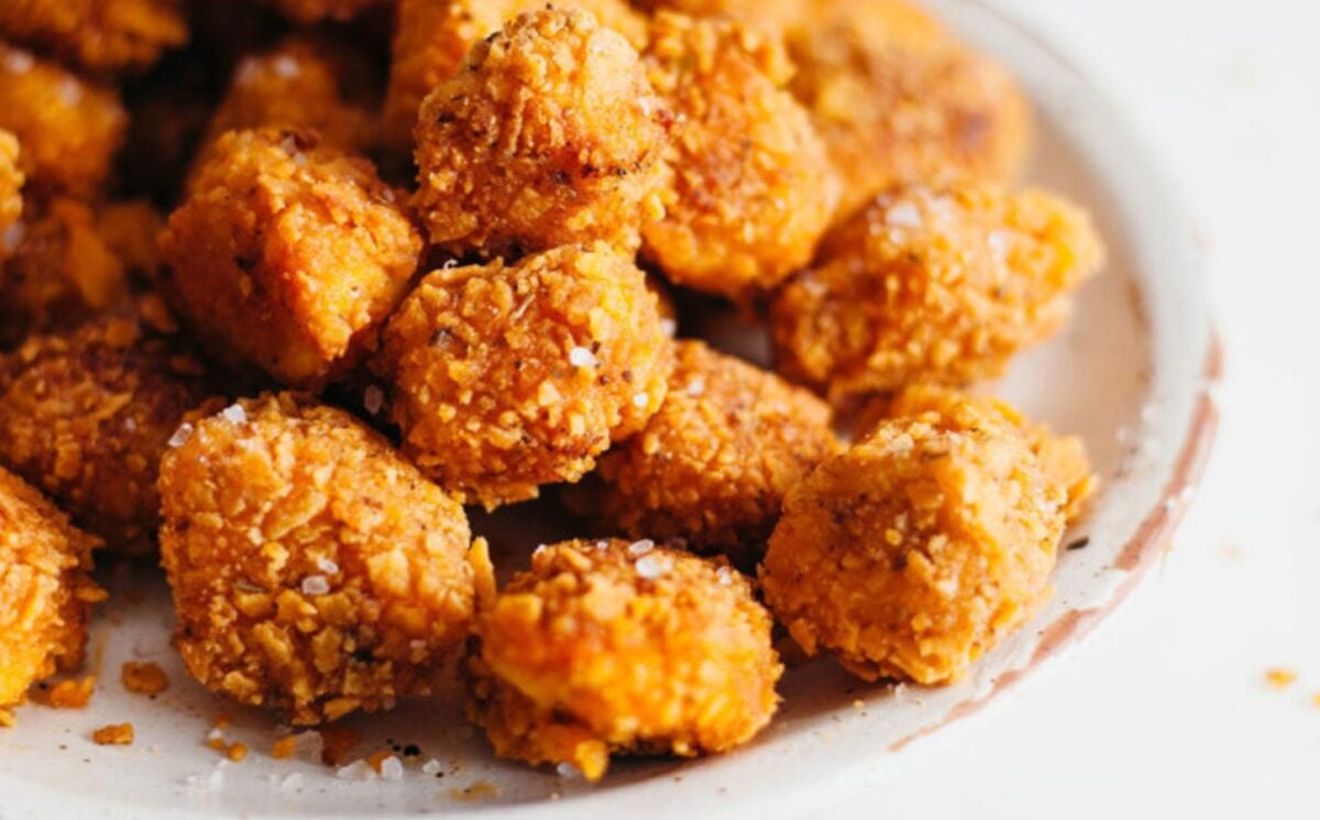 a picture of a plate of vegan popcorn 'chicken' made with tofu and battered with a flavorful crumb