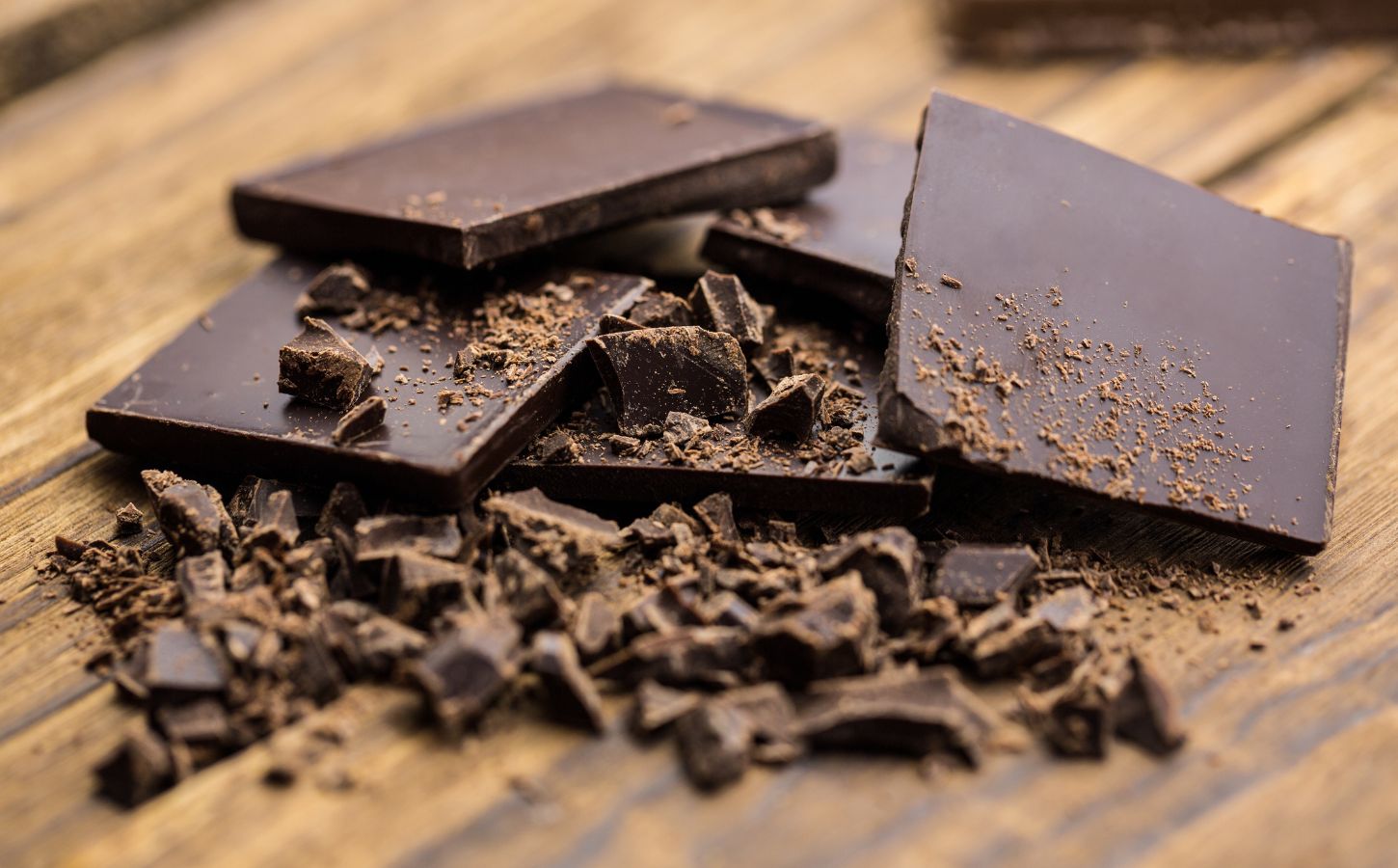 Photo shows several pieces of partially grated dark chocolate