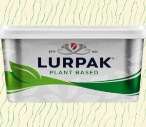 A pack of vegan Lurpak in front of a green and cream patterned background