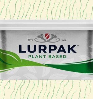 A pack of vegan Lurpak in front of a green and cream patterned background