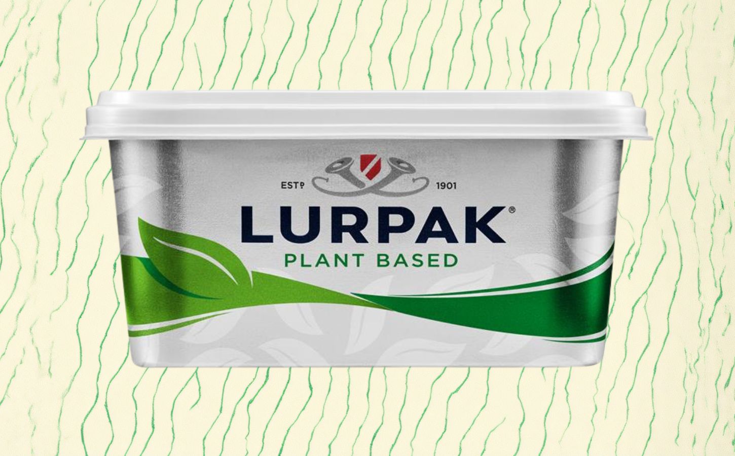 A pack of vegan Lurpak in front of a green and cream patterned background