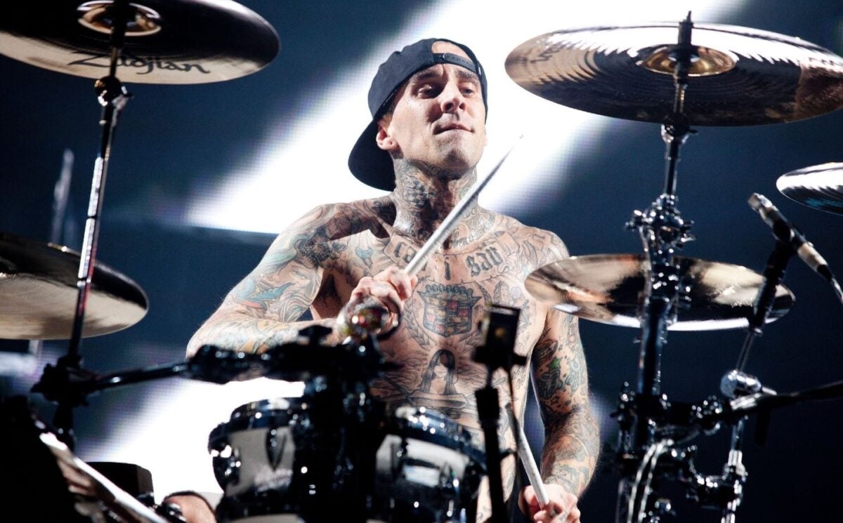 Photo shows vegan celebrity Travis Barker drumming for his band Blink 182