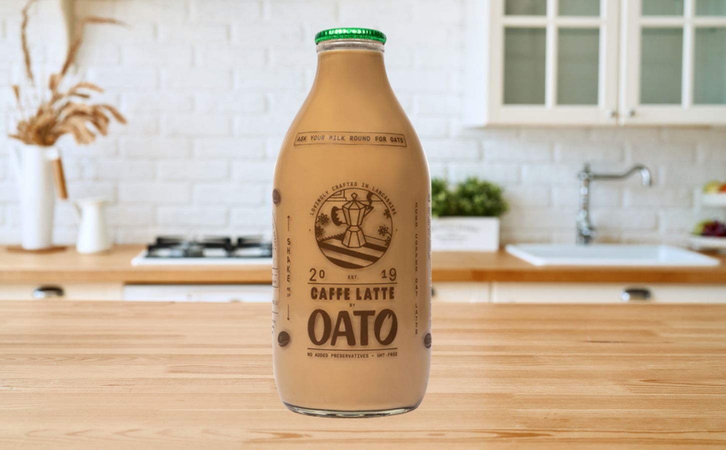 A bottle of caffe latte made with oat milk available from a UK milk round