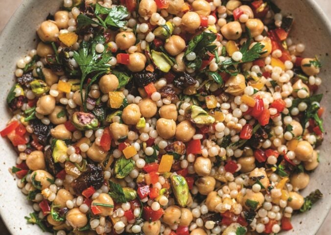 a picture of a pearl couscous and chickpea salad with preserved lemon, pepper, and other ingredients