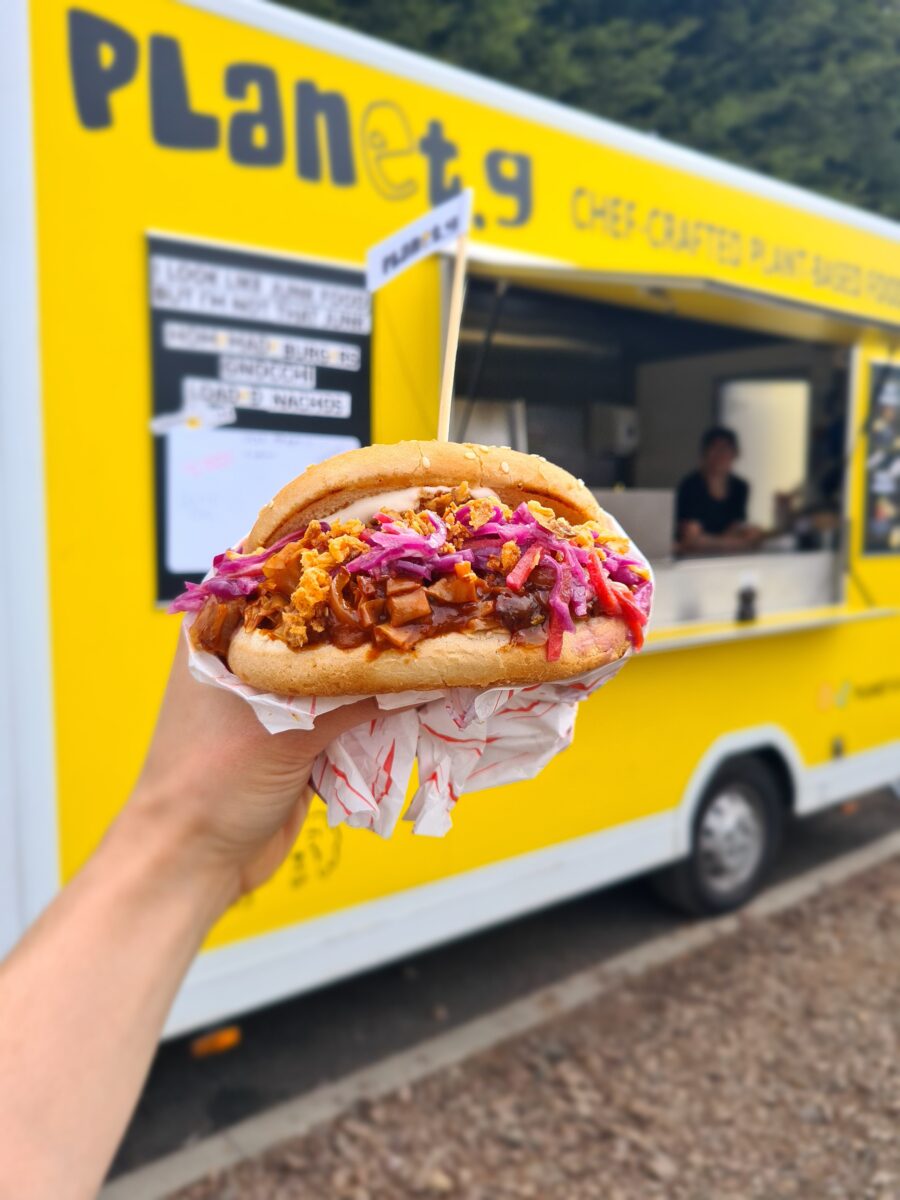 A person holding up a plant-based burger at the Planet G vegan food truck in Scotland