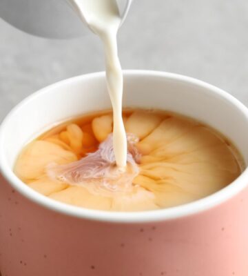 soy milk being poured into tea