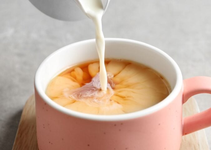 soy milk being poured into tea