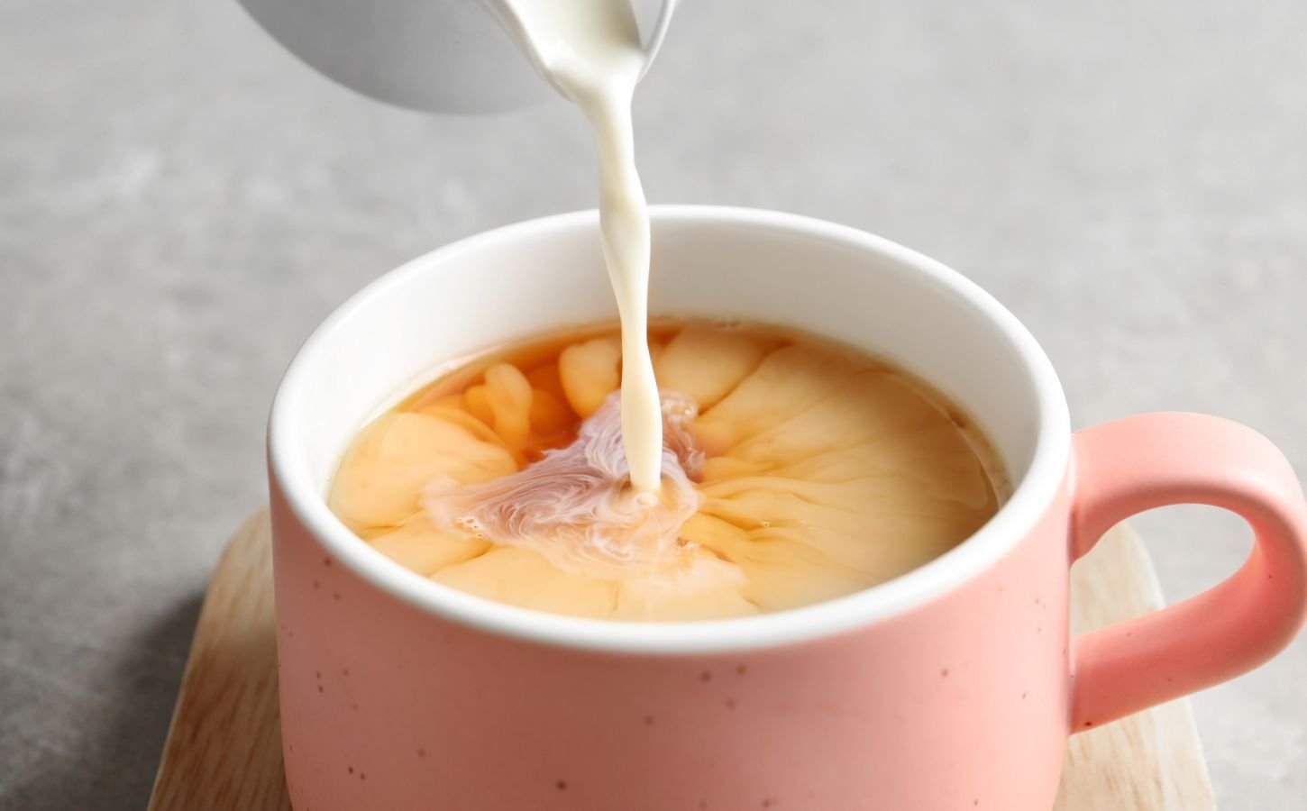 soy milk being poured into tea