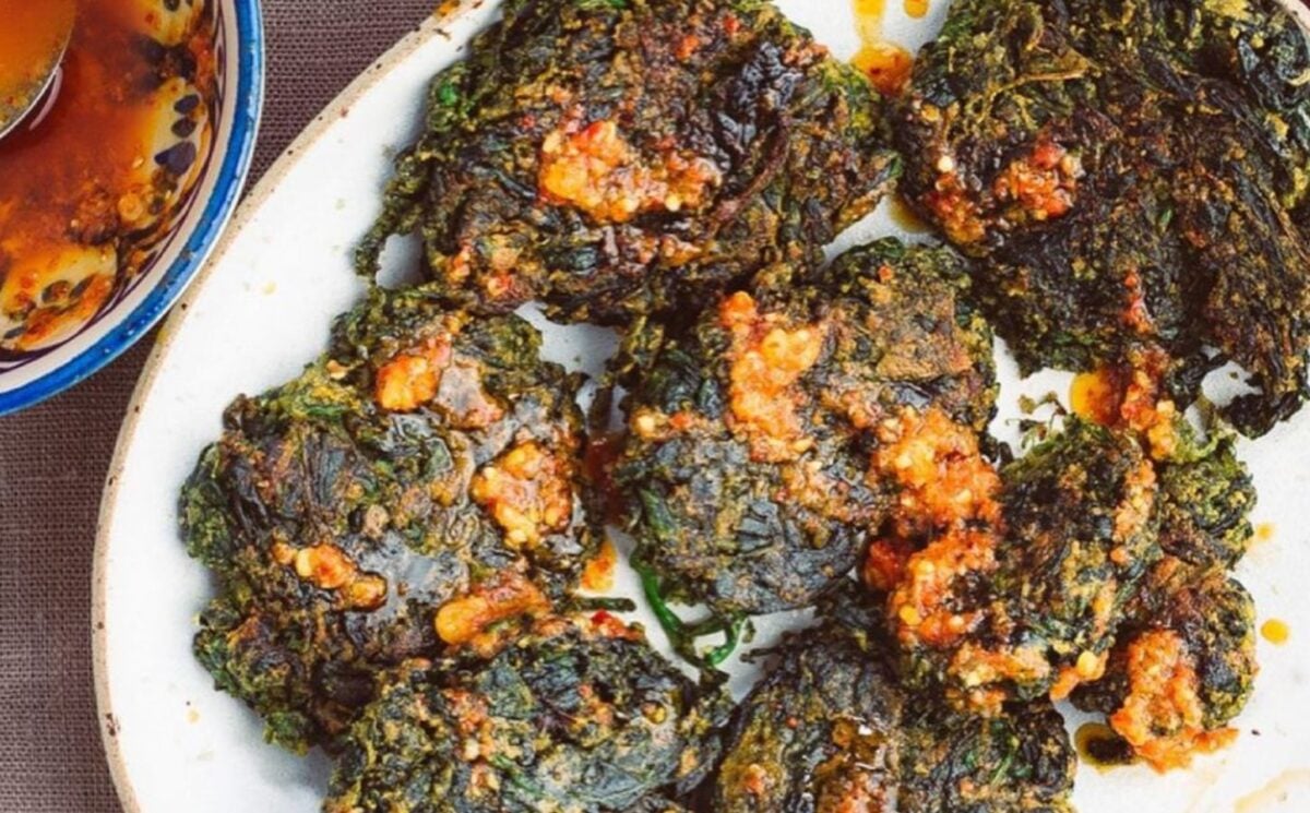 a picture of spinach fritters with chili oil and garlic made with chickpea powder and spices