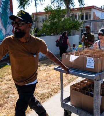 Vegan celebrity chef Supreme Dow wheeling a trolley full of plant-based meals