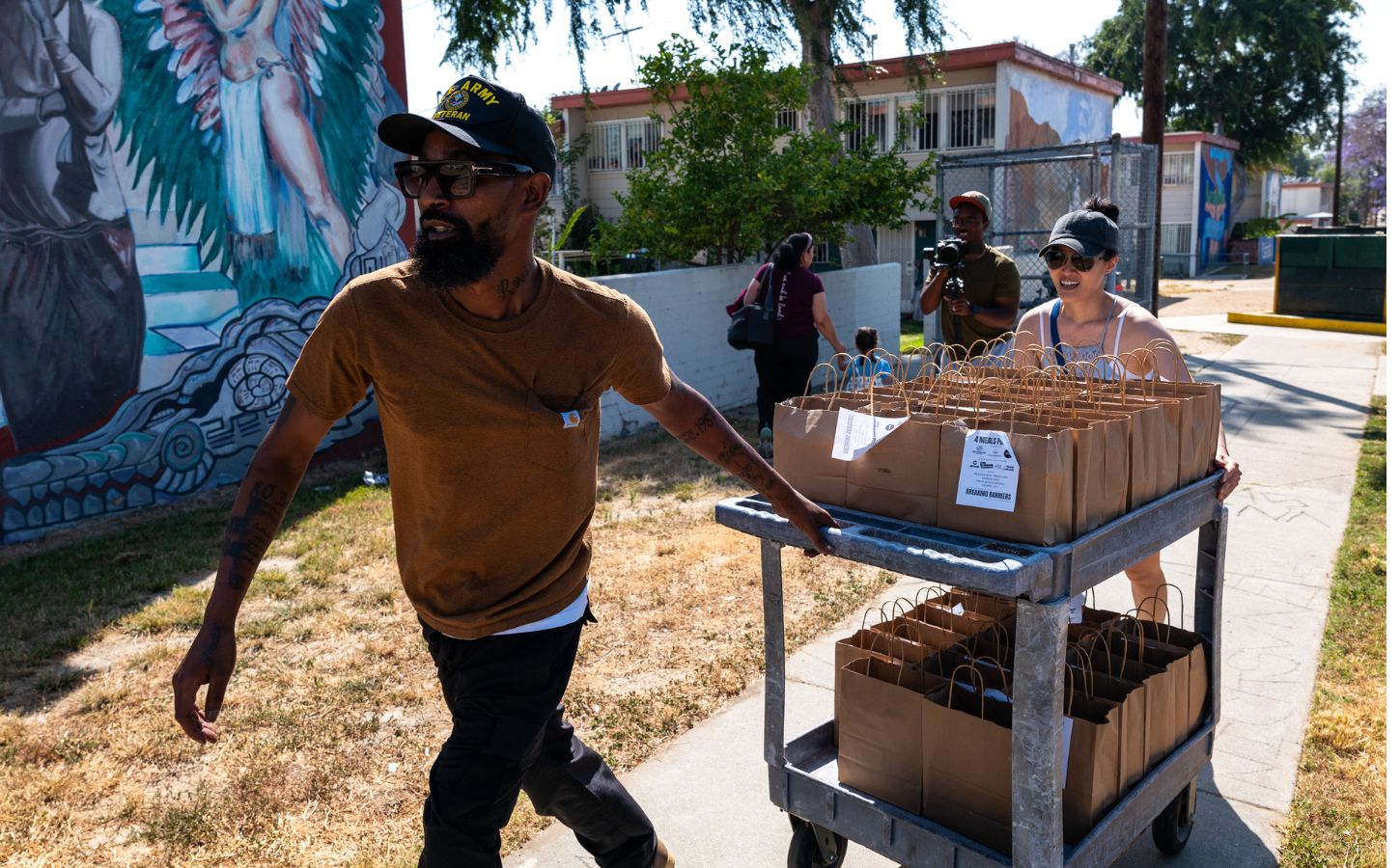 Vegan celebrity chef Supreme Dow wheeling a trolley full of plant-based meals