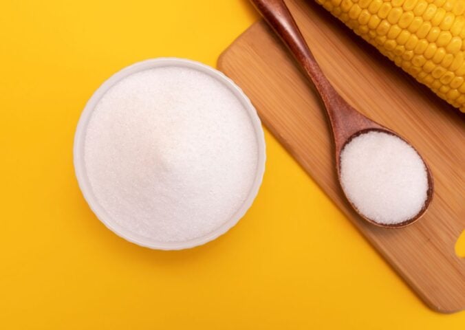 Artificial sweetener erythritol in a pot in front of a yellow background