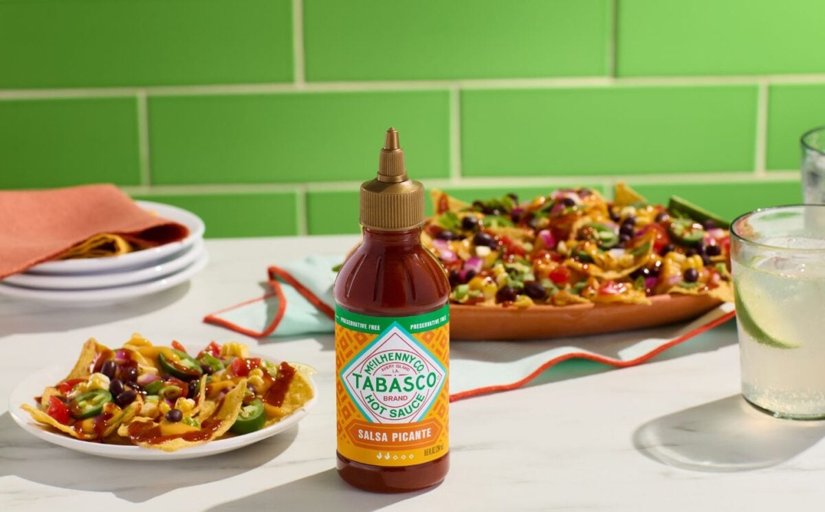 Photo shows a bottle of the new Tabasco hot sauce alongside plates of Mexican and Tex-Mex food