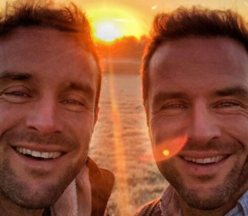 The Happy Pear owners David and Stephen Flynn pose for a selfie in front of a sunset