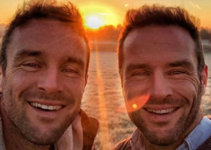 The Happy Pear owners David and Stephen Flynn pose for a selfie in front of a sunset