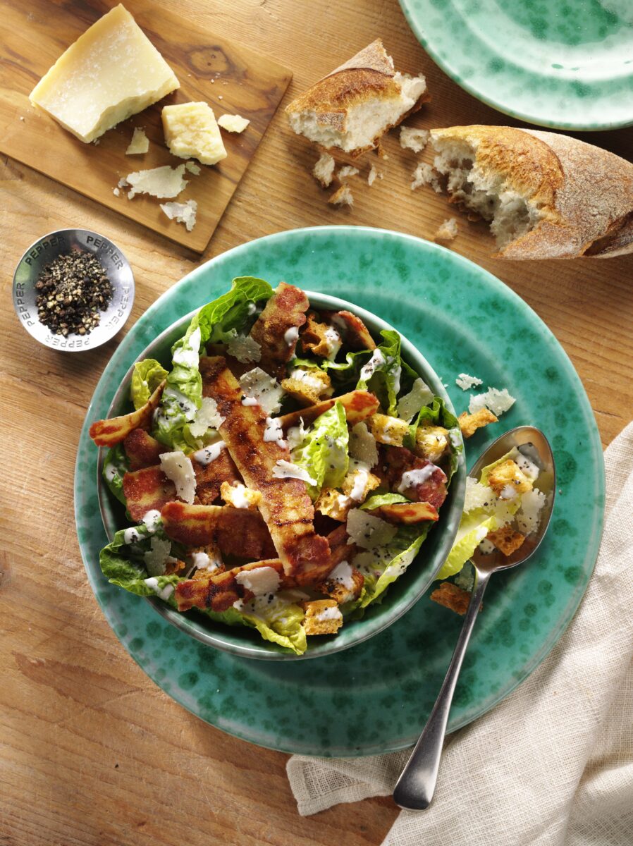 A vegan caesar salad made from Squeaky Bean vegan bacon