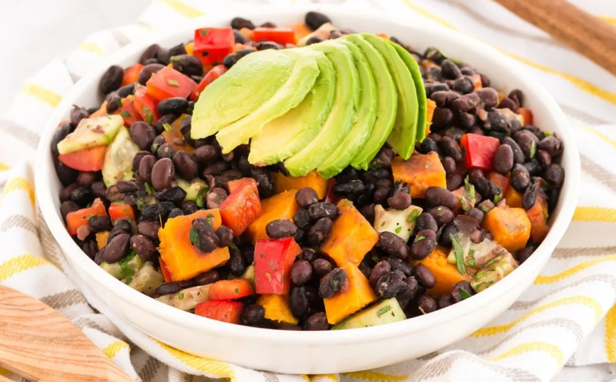 smoky sweet potato salad with black beans, bell pepper, lime, maple syrup, and spices