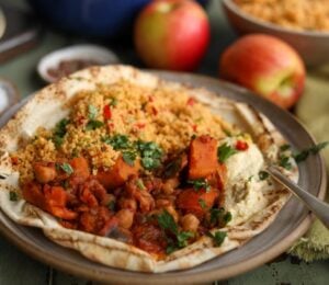 A plate of vegan apple, sweet potato, and chickpea tagine, a plant-based tagine recipe