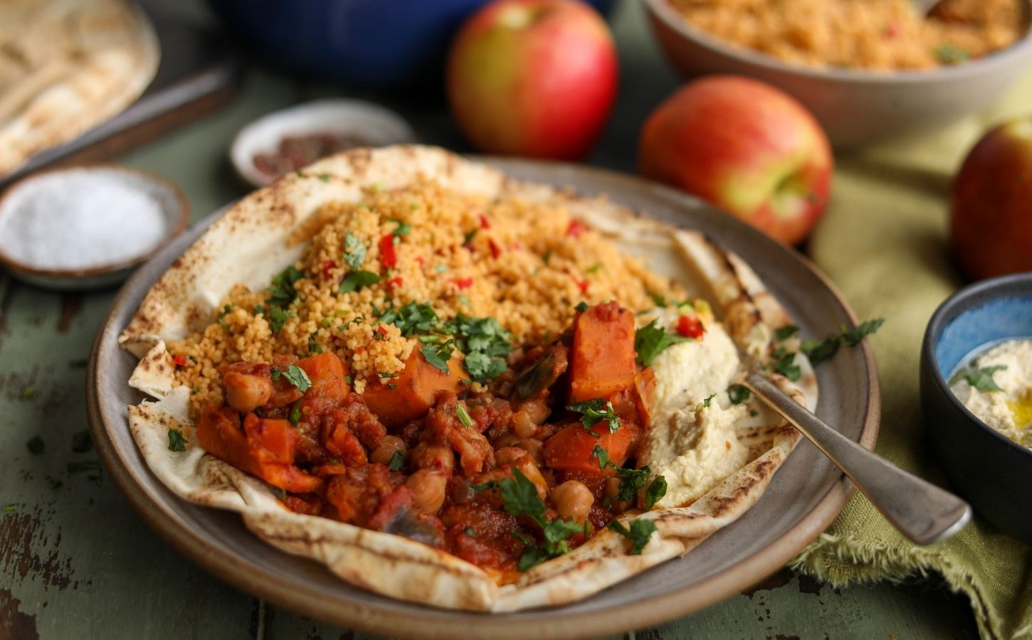 A plate of vegan apple, sweet potato, and chickpea tagine, a plant-based tagine recipe