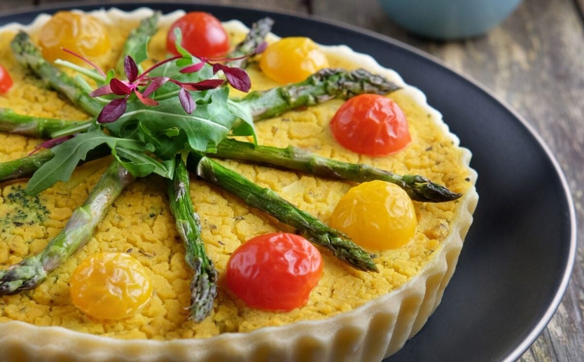 a picture of an asparagus, potato, and broccoli quiche made with chickpea flour and tomatoes