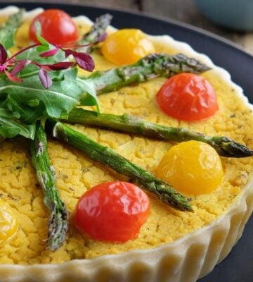 a picture of an asparagus, potato, and broccoli quiche made with chickpea flour and tomatoes