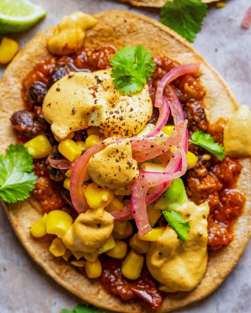 Vegan spicy black bean tostadas with a dairy-free cheese sauce